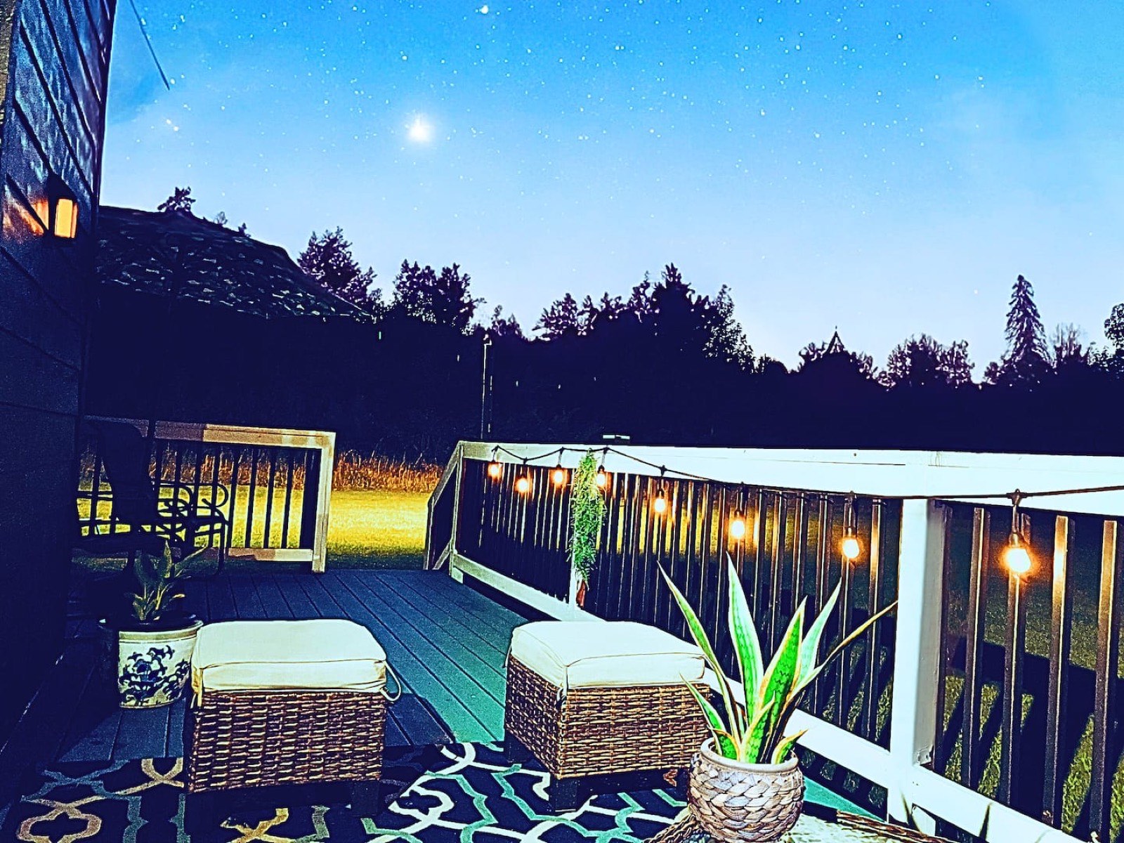 Zen Country back deck at night with string lights, set for a retreat gathering